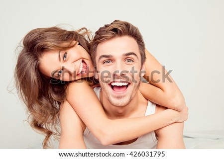 Cheerful smiling couple in love hugging in the bedroom Royalty-Free Stock Photo #426031795