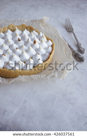 Lemon tart with meringue  on a light background, Selective focus