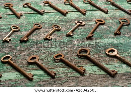 Vintage keys on wooden table top view.