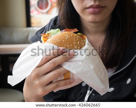 burger junk food , fast food , unhealthy with woman