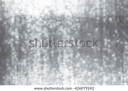 abstract white bokeh lights on grey background