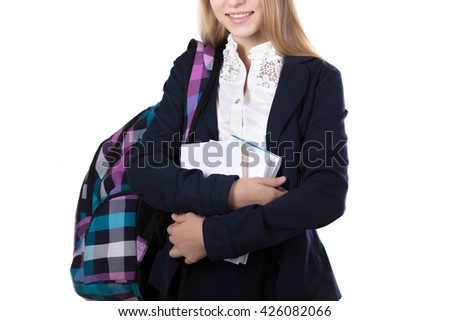 Happy beautiful girl wearing school uniform, holding stack of books and checkered bag, isolated studio shot, white background, close-up