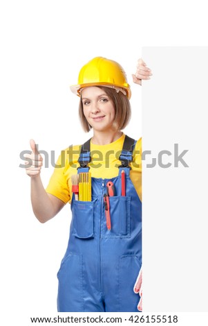 smiling construction female worker holding blank board with empty copy space for you text isolated on white background. advertisement banner. your text here. thumb up gesture
