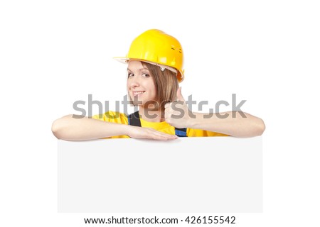 smiling construction female worker above banner with empty copy space for you text isolated on white background. advertisement blank board. your text here. thumb up gesture