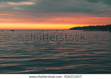Colorful sunset over Baltic Sea coast. Gulf of Finland. Background photo with tonal correction photo filter effect