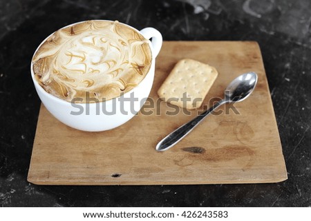Hot coffee with caramel on marble table. Selective focus.