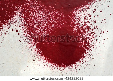 The walls are painted red old paint. The bright colored textured background. Macro photo. Paint splashes
