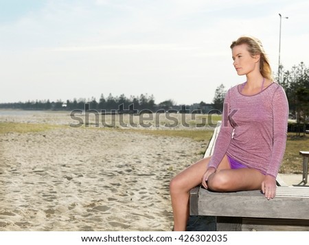 Young woman gazing from pier, Altona, Melbourne, Victoria, Australia