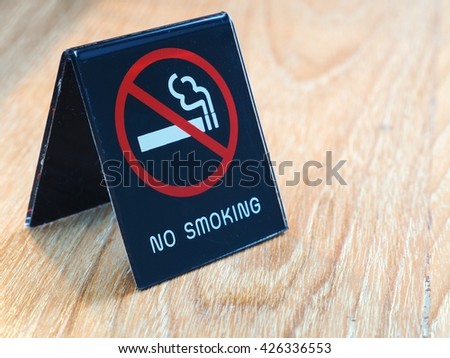 No smoking sign on wooden table in the hotel