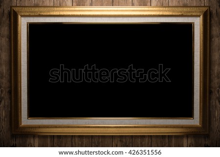 old gold frame on wood wall
