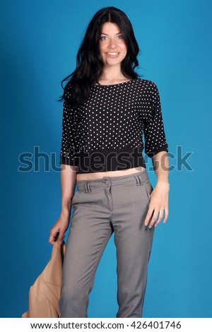 Beautiful young girl  posing on a blue background