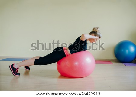 Good sports girl does stretching fitness room in the morning