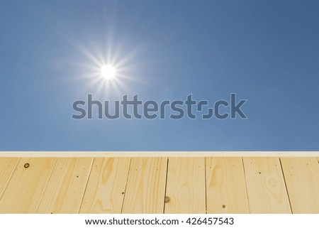 Wood table top on blue sky background - used for background , display your products or backdrop in nature concept