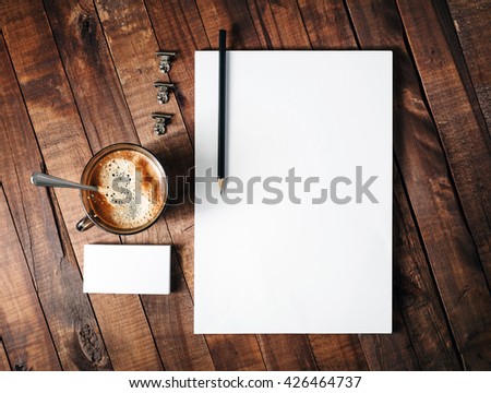 Photo of blank stationery set on wooden table background. Template for design portfolios. Corporate identity template. Blank branding mock-up. Top view.