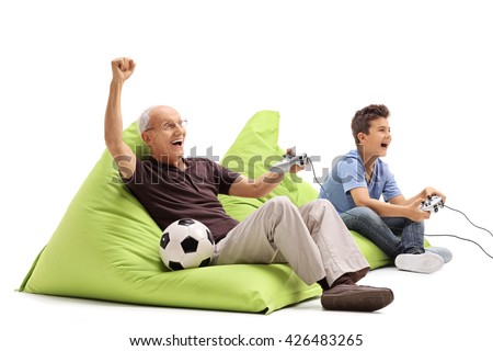 Studio shot of a senior man playing video games with his grandson isolated on white background Royalty-Free Stock Photo #426483265
