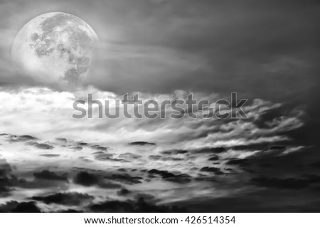 Attractive photo of a beautiful sky with clouds, bright full moon would make a great background. Beauty of nature use as background. Outdoors. Black and white picture style.