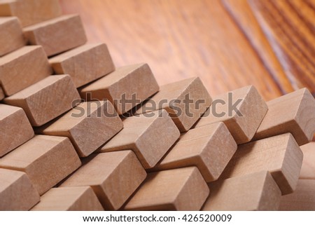 Wooden blocks are on the wooden floor background.