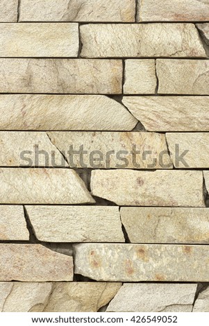 wall of an old golden travertine facing brick