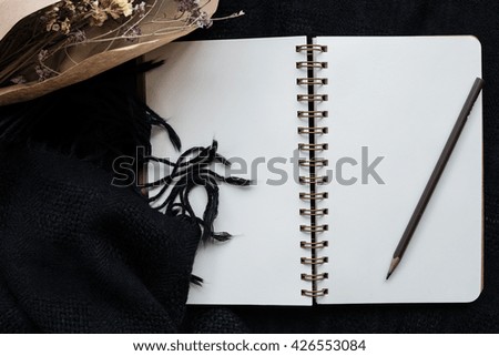 Notebooks, Pencil , Flower on a black background