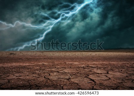 Land to the ground dry cracked. With lightning storm Royalty-Free Stock Photo #426596473