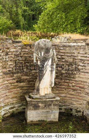 Ancient ruins and woman statue in the Dion Archaeological Site in Greece