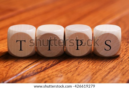 TIPS word wooden blocks are on the floor.