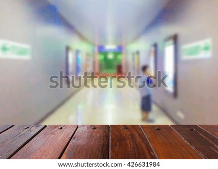 Look out from the table,blur image of boy and walkway in cinema as background.