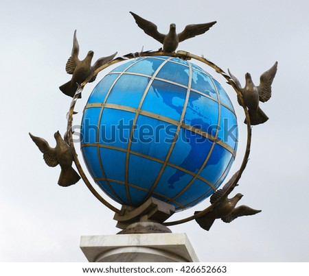 The statue shows Pigeons carry globe