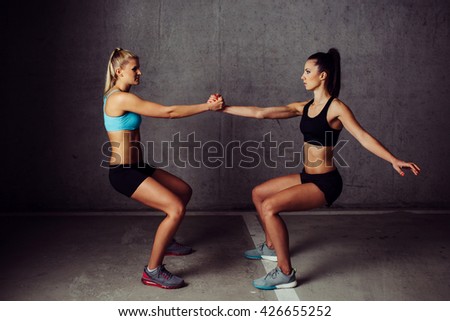 Two women training legs together