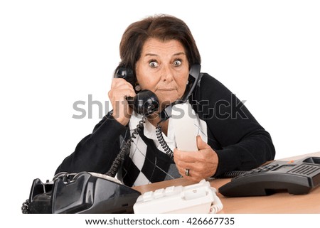 Desperate senior woman with several phones isolated in white