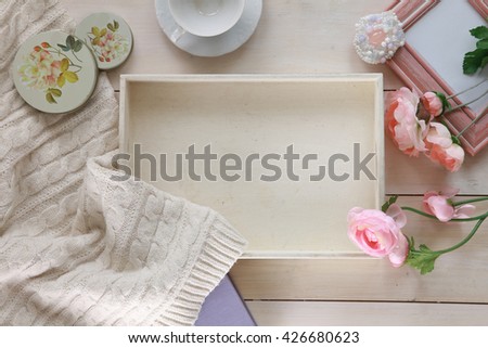 romantic breakfast in bed. the morning light still life on a white wooden table. view from above. style shabby chic, vintage. White tray breakfast, pink peonies, cup, frame, white blanket.