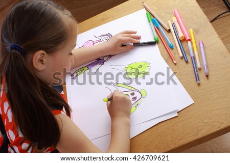 Girl in red dress draws a picture of the family. children's fears, bad dreams, nightmares. 
