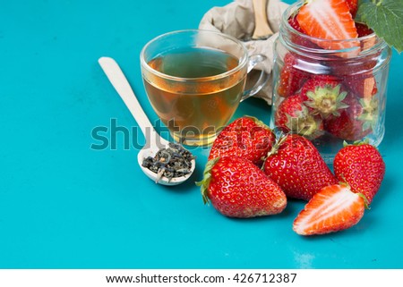 fresh strawberries on a bright background. Fruit tea with strawberries on a wooden spoon.  Food Frame Background with space for advertising text. soft selective focus Photo