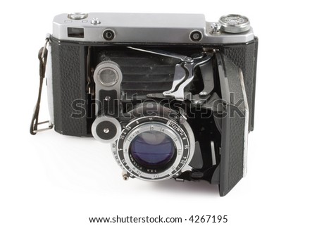Old folding camera isolated on white background