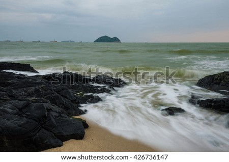 Rocks and ocean water flowing over them taken with slow shutter speed.samila beach,Songkhla Thailand.