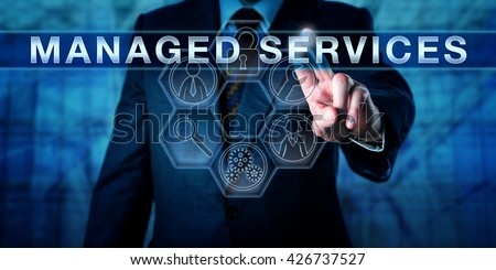 Male business consultant is touching MANAGED SERVICES an a virtual interactive control interface. Information technology concept and business metaphor for outsourcing management responsibility. Royalty-Free Stock Photo #426737527