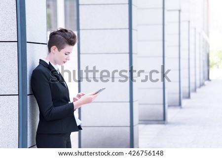 Modern business woman holding tablet