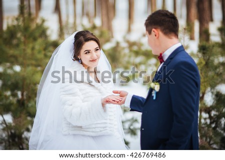 Happy bride and groom in winter day on their wedding, photo session.