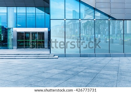 buildings and clean road reflected on the glass wall Royalty-Free Stock Photo #426773731