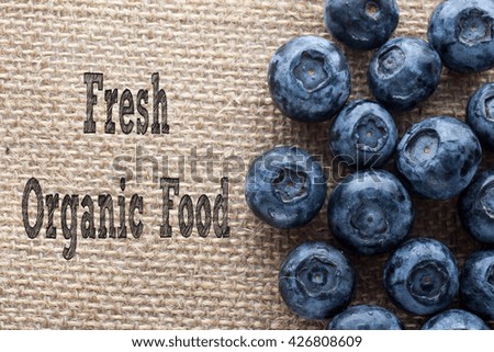 Fresh Organic Food written on burlap with fresh blueberrys,conceptual