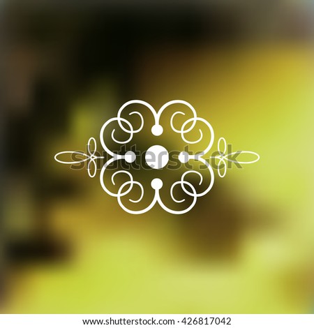 Decorative floral logo on blurred backgound