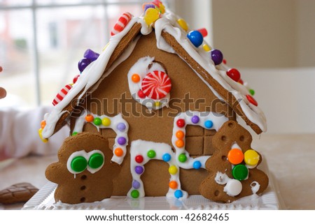 Gingerbread cookie house dotted with colorful candy
