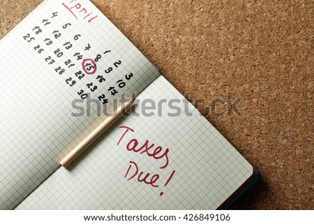 Tax day reminder in a notebook, close up