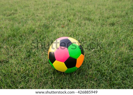Colorful football on grass field
