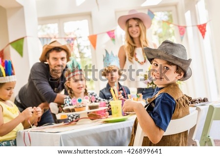 Portrait of parents and children at kids birthday party