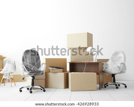 Moving cardboard boxes and personal belongings in empty office space Royalty-Free Stock Photo #426928933