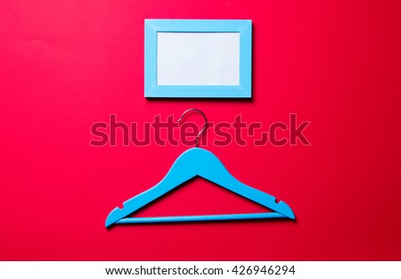 photo frame and blue hanger on the red background