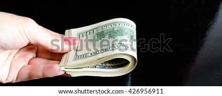one hundred dollars in woman hand
