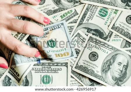 one hundred dollars in woman hand