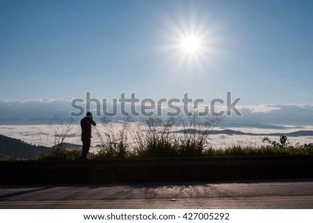 silhouette of photographer with fog
